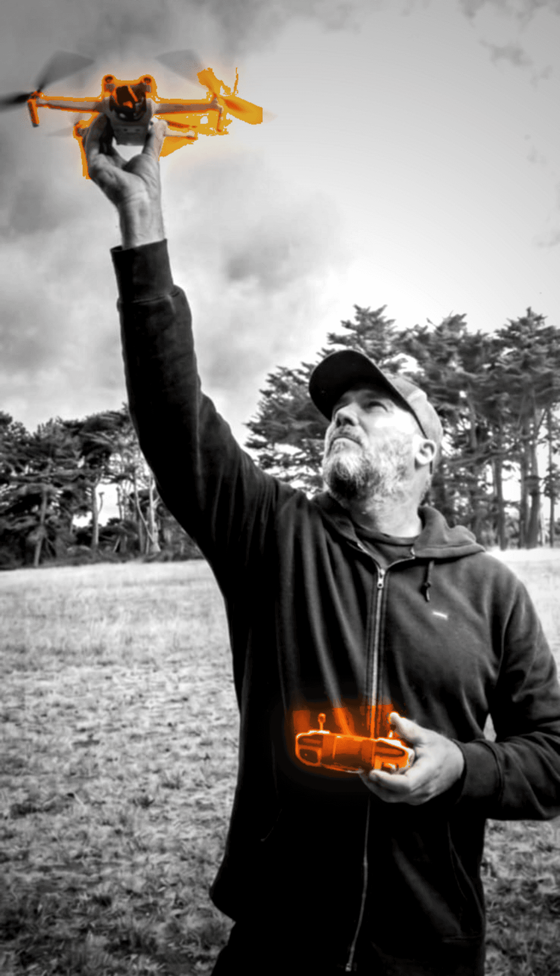 Sean Dewil, founder of BlueCurve, launching a drone in an open field